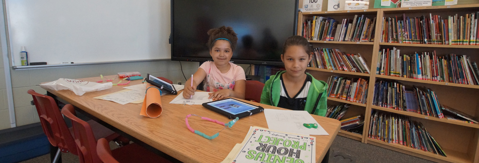 Two female students making jewelry in the Learning Commons