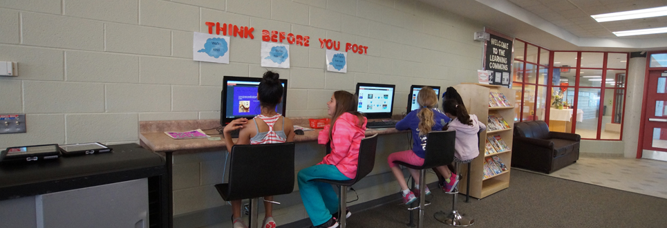 Four female students working on computers in the Learning Commons